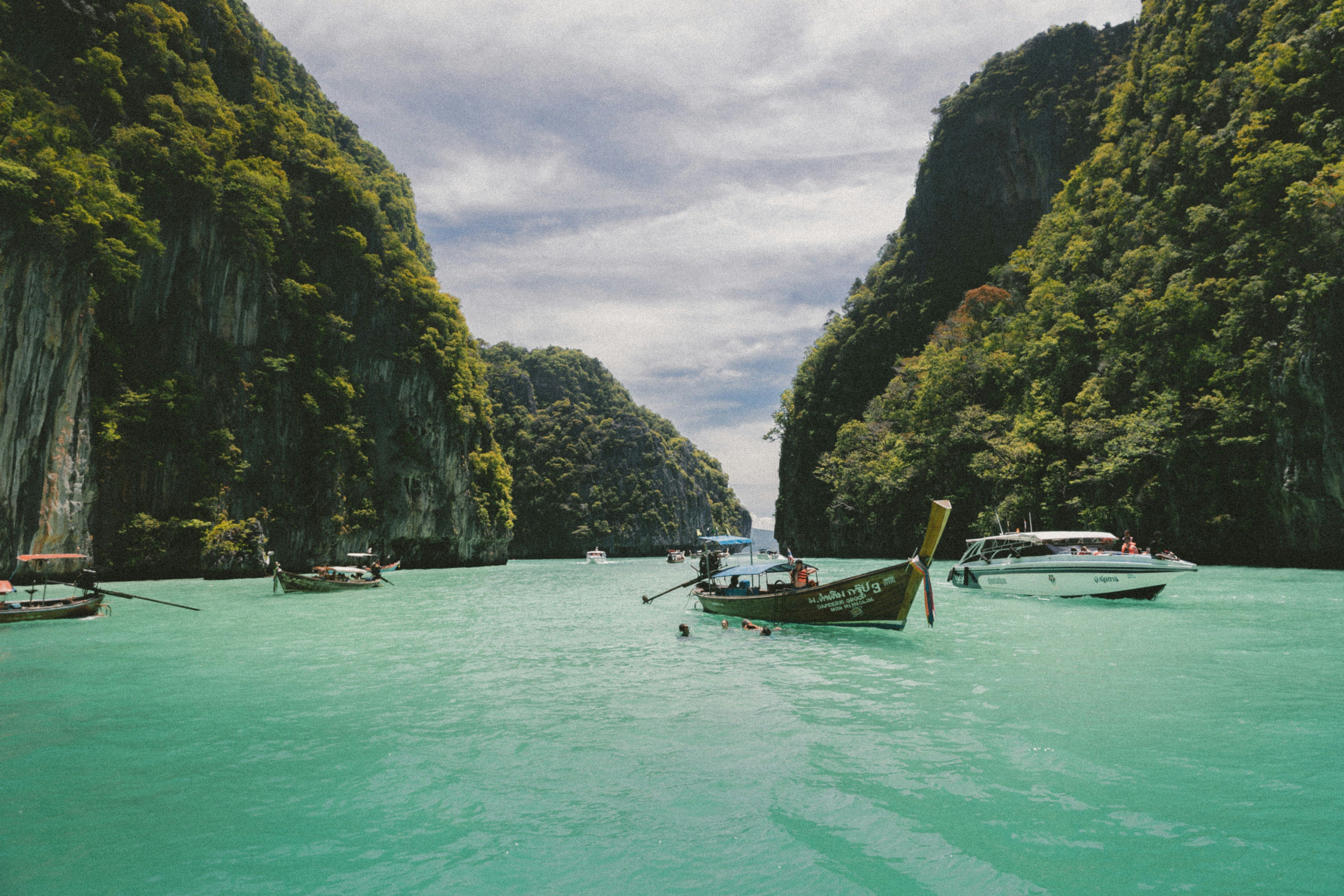 Crystal-clear blue waters dotted with boats.