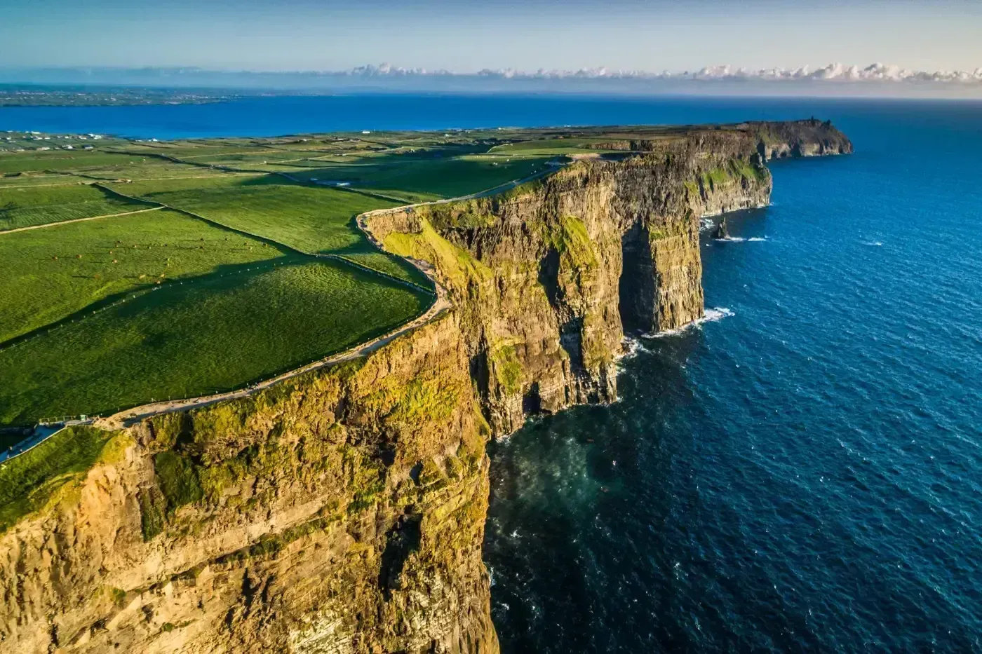 idyllic image of Ireland's green coastline and crystal blue waters
